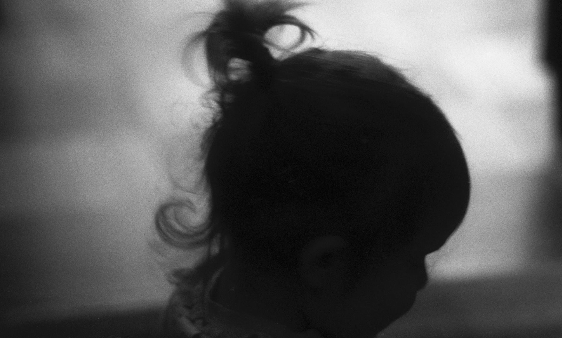 A photograph of a small child's head in silllouhette 